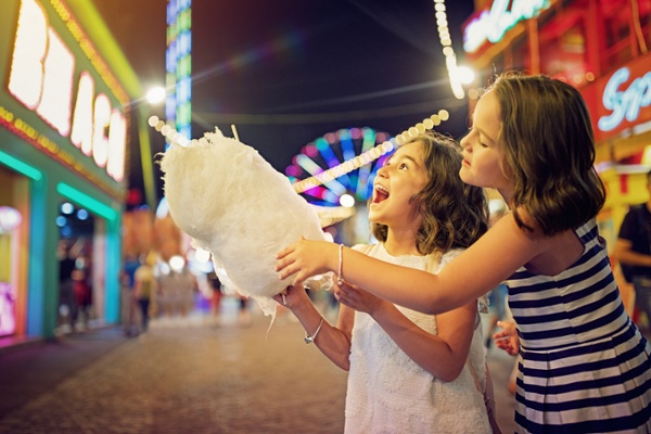 Visitors eating cotton candy with no pest birds around because of the parks theme park bird control plan